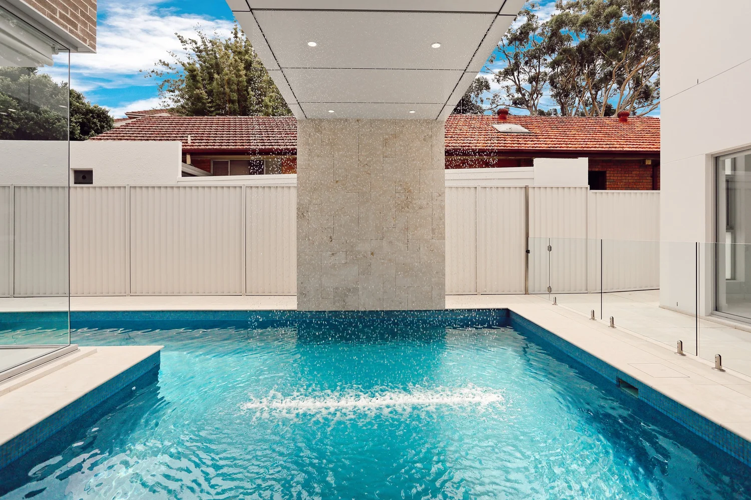 Architectural pool coordinated with an Oatley home and landscape
